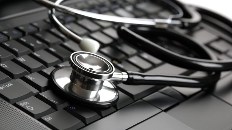 Stethoscope resting on a computer keyboard