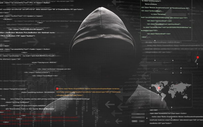 Image of a hacker with code overlayed